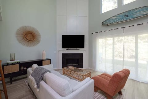 Relax in the coastal-inspired living area featuring airy décor and plenty of natural light.