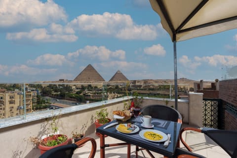 Panoramic Double Room, City View | Breakfast area | Free daily continental breakfast