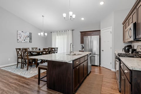 Your spacious kitchen features granite countertops, stainless steel appliances, and a large island perfect for cooking together and memorable meals.