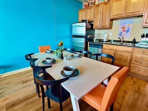Gather around our stylish kitchen table with seating for six. Perfect for meals or game nights, this spacious area fits seamlessly into the vibrant 80s-themed decor, offering a fun and welcoming space for all guests.