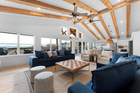 A grand open concept living space with rustic wood beams!