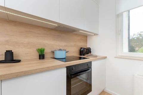 Bright kitchen with cooking utensils. 