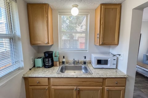 The kitchen comes with most of your cooking needs. Including a microwave, toaster, coffee maker, and all cutlery.