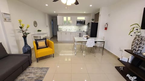 Step into an open floor plan with a sitting room, dining area, and kitchen.