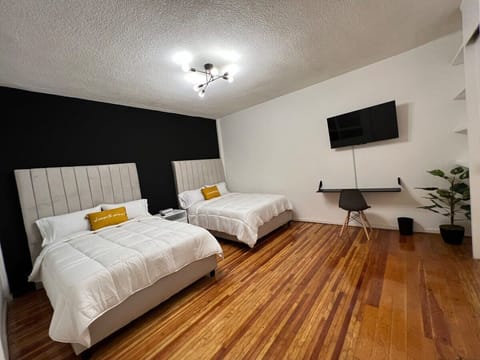 Bedroom 1 with 2 double beds and a convenient desk area.