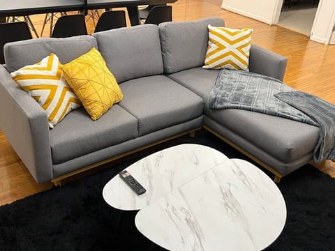 Relax on the spacious sofa while enjoying your favorite shows on the Smart TV.