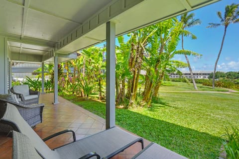 Your private covered lanai opens to lush tropical gardens with swaying palms and vibrant greenery, perfect for morning coffee or sunset relaxation in pure island serenity.