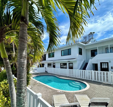 newly painted front exterior of triplex, shared heated pool