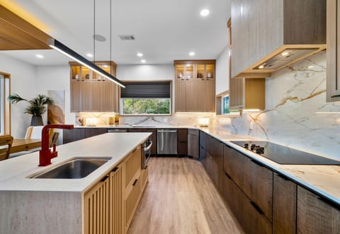 Chic culinary space with sleek fixtures and marble splashes—perfect for creating and tasting