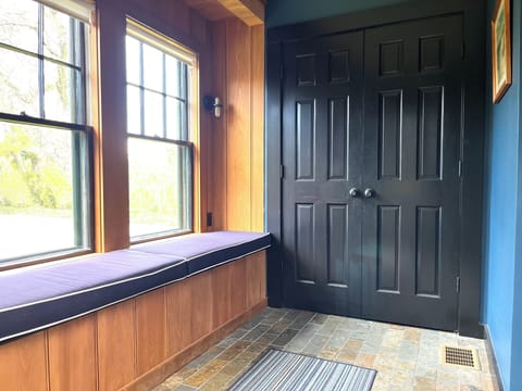 Side entrance to kitchen with window seat and laundry in closet.