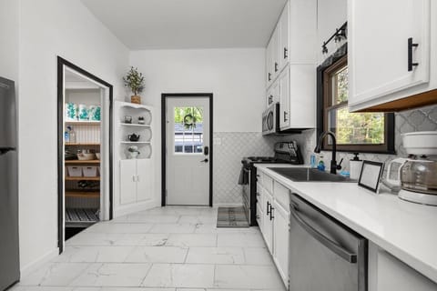 Another perspective of the kitchen, showing the pantry.