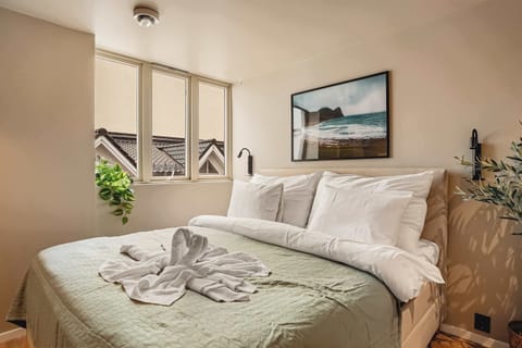 Inviting bedroom with double bed and local artwork