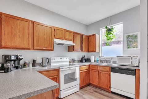 Enjoy the convenience of a modern kitchen with a dishwasher, microwave, and plenty of cabinet space—making your stay as seamless as possible.