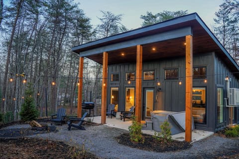 Private exterior with charcoal grill, hot tub, and fire pit.