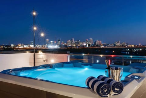 Unwind under the stars in your private hot tub, soaking in breathtaking skyline views of Music City. Experience ultimate relaxation and luxury at this chic Nashville rooftop retreat. Perfect for your next getaway! Book now with Misfit Homes.