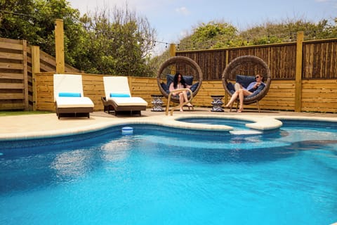 Pool with spa chaise lounges , egg chairs and outdoor sectional