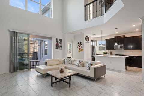 Spacious modern living room with high ceilings and playful Disney touches throughout.