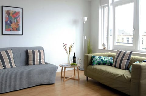 Bright living room with city views
Relax on comfortable sofas and enjoy the natural light streaming through large windows.