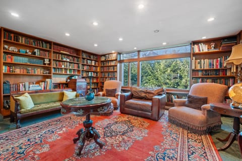 Full library with beautiful wood shelving. 