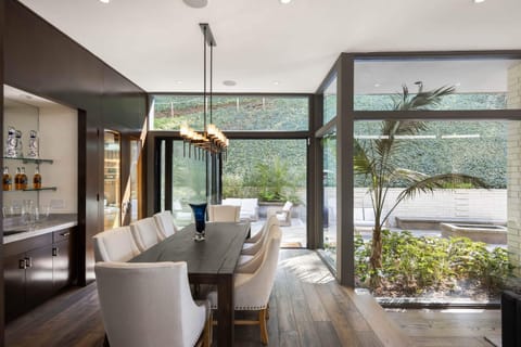 Indulge in gourmet delights in the dining room, equipped with sleek countertops and elegant seating.