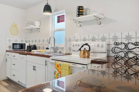 Full kitchen space which includes electric stove, microwave, dishwasher, and refrigerator