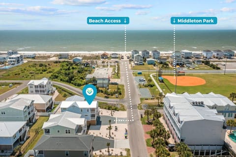 Aerial Oak Island map view with rental marker, nearby beach access path, Middleton Park label, oceanfront homes, road, ballfield, and Atlantic Ocean.