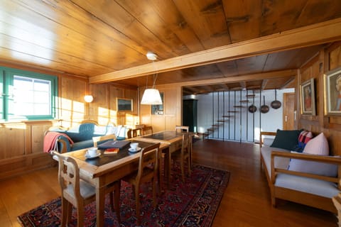 Cozy living and dining area with dining table and seating areas