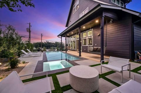 32 foot pool with built in hot tub, multiple seating areas, sun loungers and grill!
