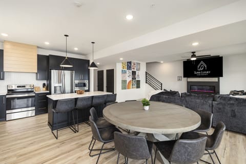 Main Level: Dining Room & Kitchen seating 12 at dining table & 4 on bar stools