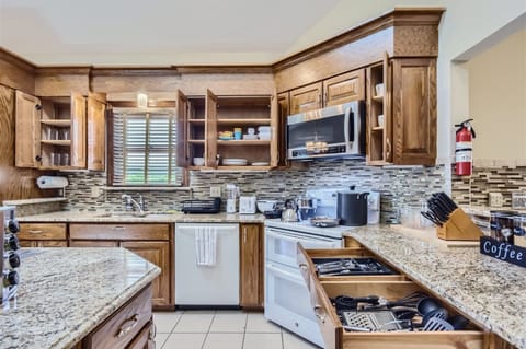 Enjoy the full kitchen with filtered water, refrigerator, freezer, oven, stove, microwave, dishwasher, coffee, creamers, mixers, spices, pots, pans, cooking supplies, cutlery, cups, plates, bowls, utensils, small appliances, and many more essentials!