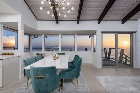 Dining table set sits 6 people comfortably. Ocean views thru a wall of windows.
