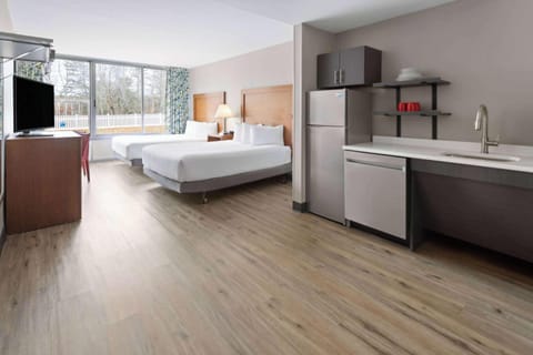 Room, 2 Queen Beds (Mobility/Hearing, Kitchenette) | Desk, blackout drapes, iron/ironing board, free cribs/infant beds