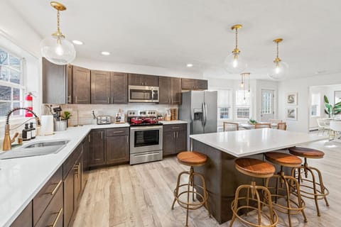 Cook up a feast in our spacious, fully equipped kitchen with modern appliances, a large island, and plenty of counter space for family meals and gatherings.