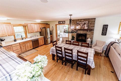 Wide view of the open-concept kitchen and dining area in a Bryson City farmhouse, perfect for large families or groups visiting Western North Carolina.