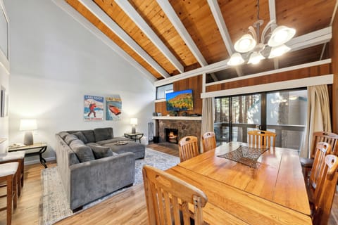 Cozy up in your mountain retreat with soaring wood beam ceilings, a gas fireplace, and comfortable seating perfect for après-ski relaxation.