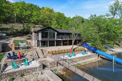 Water's Edge is an epic lake experience with hot tub, lake slide, beach, dock, sand volleyball and more!