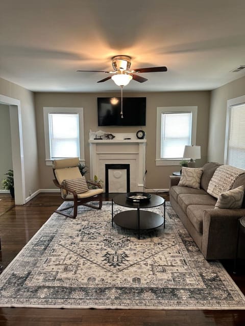Bright & airy living room with cozy seating, fireplace, and smart TV — your home away from home