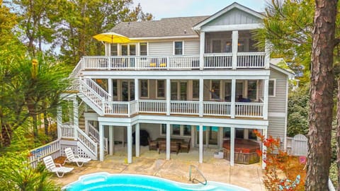The fenced-in entertainment area boasts a private pool, bubbly hot tub, and lounging furniture!