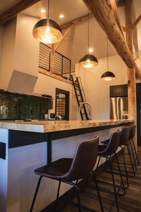 Kitchen with live edge slab bar seating, floating shelves is fully stock.