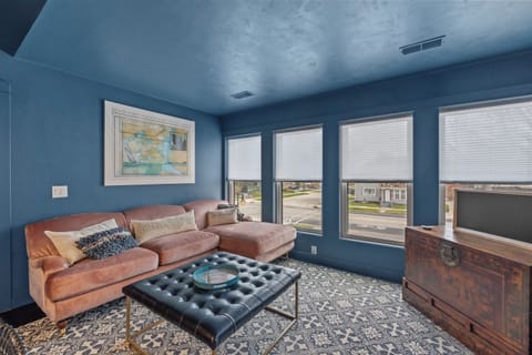 Spacious living room w/ plush seating, perfect for relaxing together.