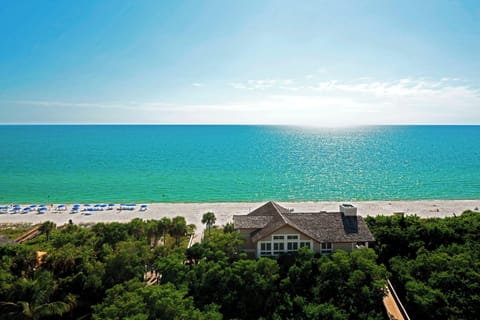 On the beach, white sand, beach cabanas, sun loungers