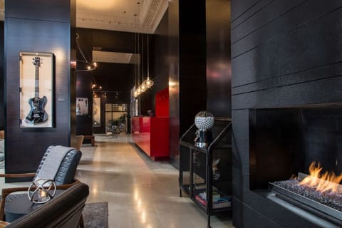 Step into the warm embrace of Hotel Max's stylish lobby, complete with a welcoming fireplace.
