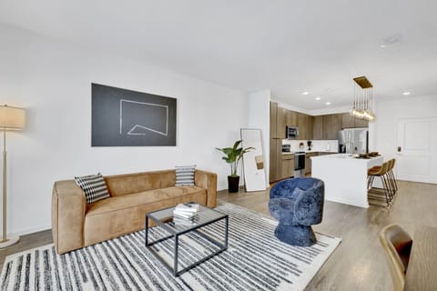 An elegant living area in Downtown Birmingham that blends modern design, natural light, and cozy touches for the perfect stay.