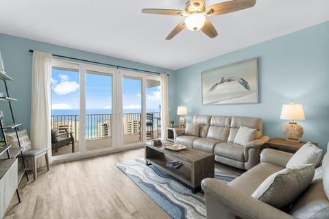 Relax in this coastal living room with ocean views through large glass doors.