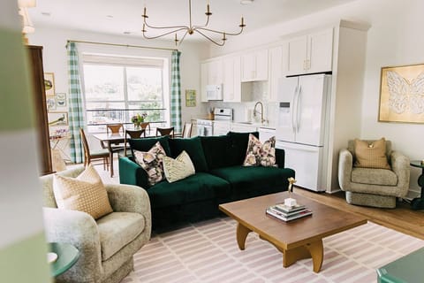 Living room with natural light and views of Midtown. Dining table with 6 seats. 