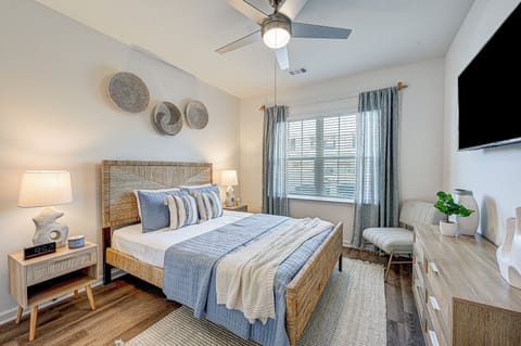 Queen Bed w/Smart TV and Two Nightstands w/Charging Stations.