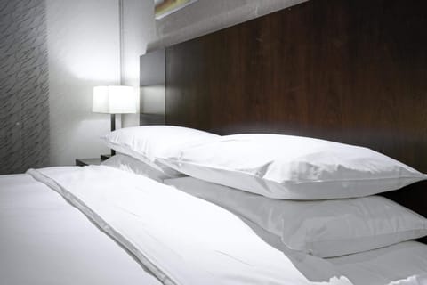 Premium bedding, desk, laptop workspace, blackout drapes