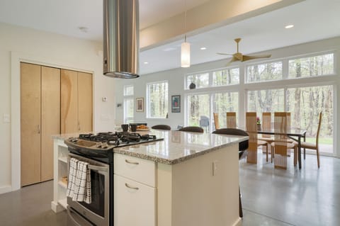 Fully equipped kitchen with stainless steel appliances and a gas range.