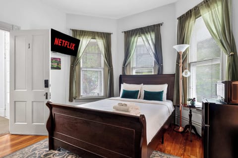 Bedroom 1: Relax in this cozy bedroom featuring a comfortable queen bed, soft linens, and a peaceful atmosphere perfect for restful nights and relaxing mornings.