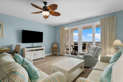 Relax in this coastal-style living room with a balcony view of the ocean.